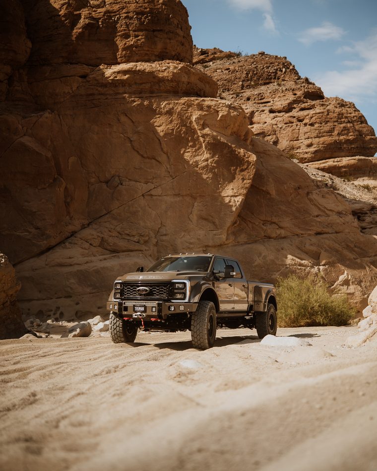 Truman Motors Super Duty sitting level on broken rock in a canyon wash