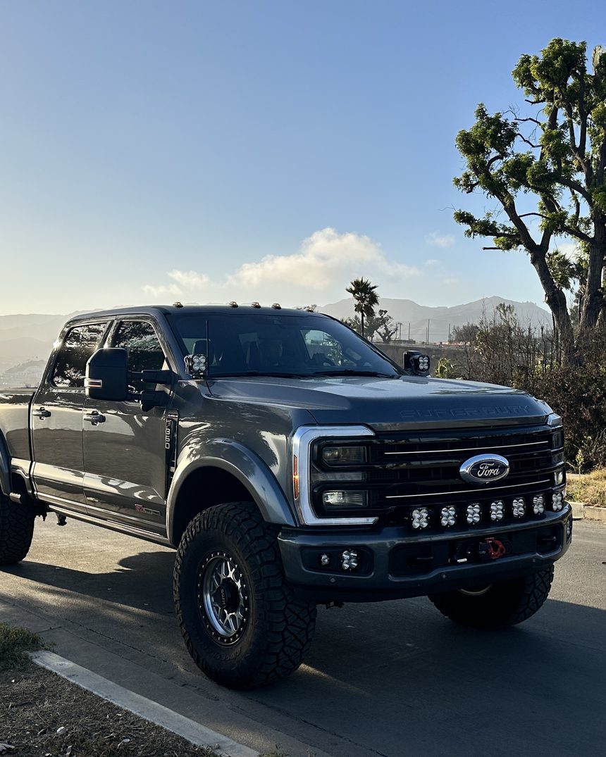 Truman Super Duty on a coastal highway at sunset