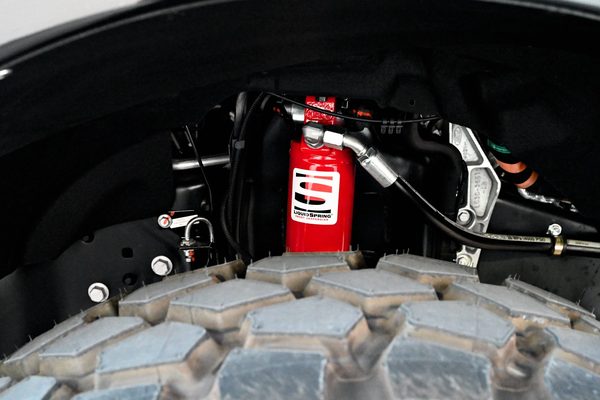 Active suspension hardware mounted inside the wheel well